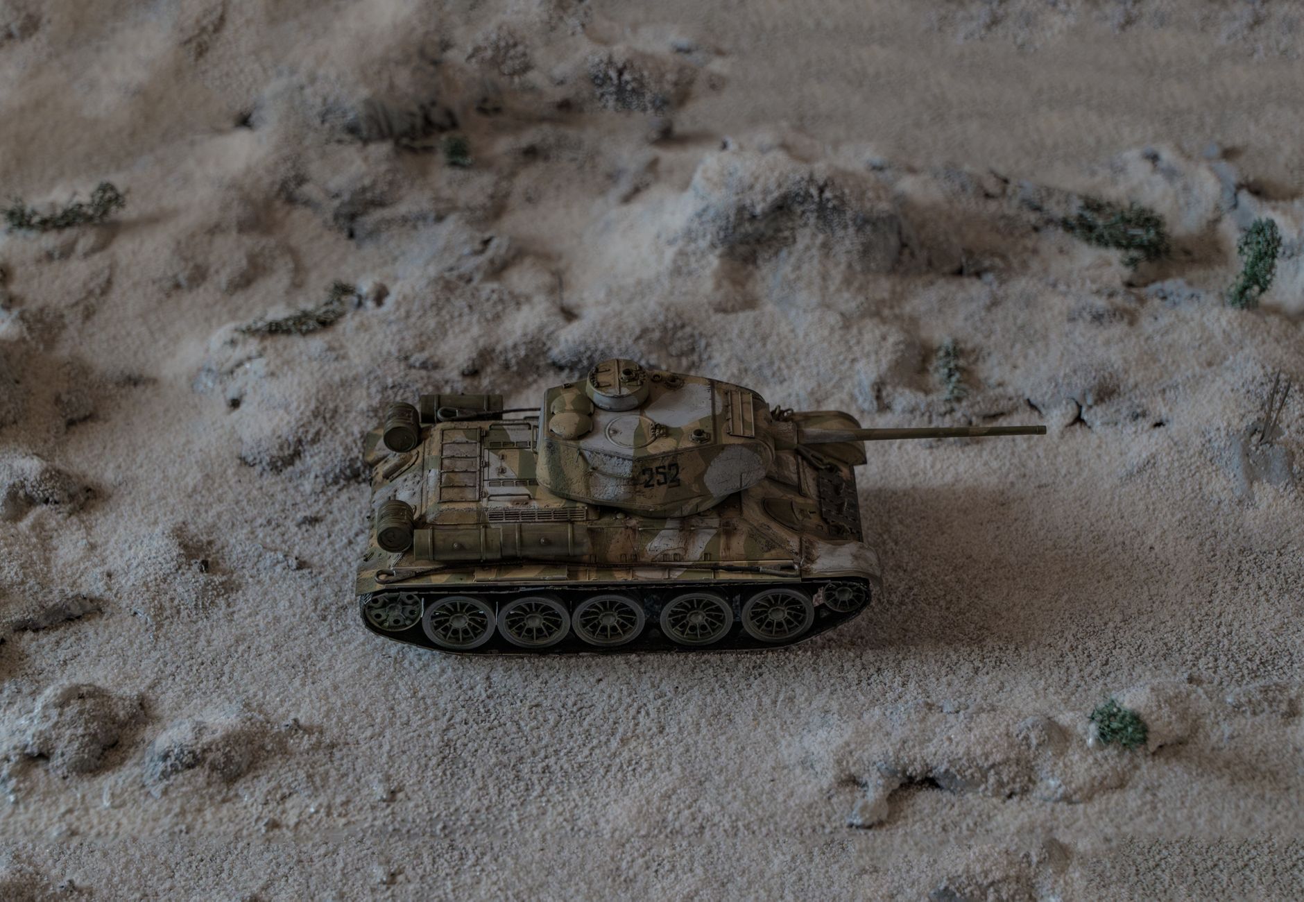 Detailed diorama featuring a miniature tank on a snowy battlefield.